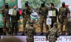 Hamas hands over six hostages but Israel suspends release of 600 Palestinians